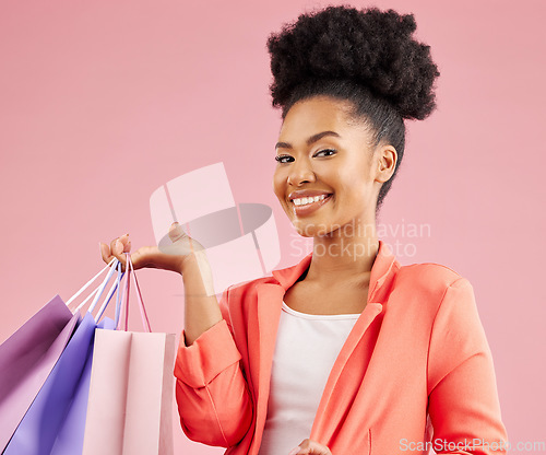 Image of Happy African woman, shopping bag and studio portrait for discount, sale or smile by pink background. Young gen z girl, promotion and excited for deal, retail customer experience or fashion for gift