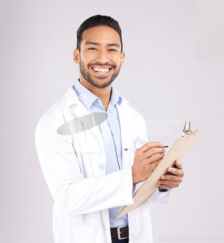 Image of Portrait, smile and happy man doctor with checklist in studio for medical, compliance or insurance on grey background. Healthcare, form and face of male health expert checking paperwork or agenda