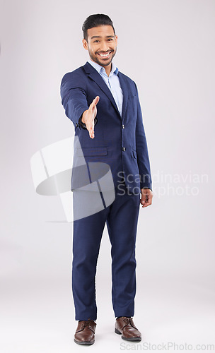 Image of Happy businessman, portrait and handshake for meeting, introduction or greeting against a grey studio background. Asian man shaking hands for business opportunity, hiring or deal in team agreement