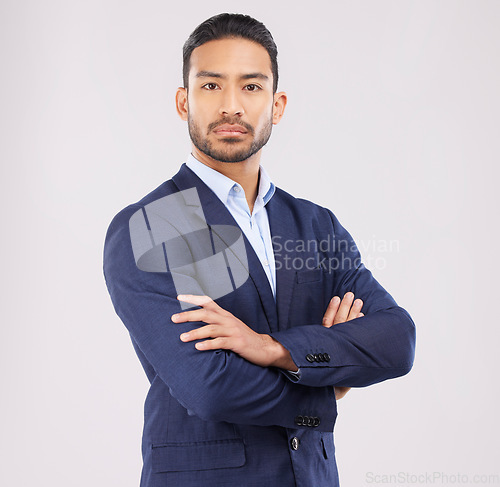 Image of Business man, arms crossed and studio portrait with serious face, ambition or mindset by white background. Asian entrepreneur, financial advisor and suit for corporate fashion with professional style