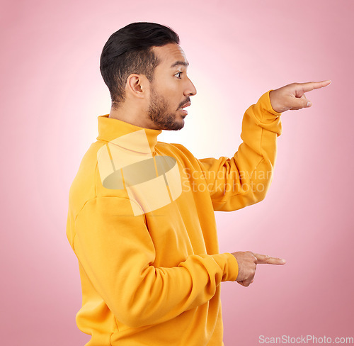 Image of Man, presentation and pointing to surprise, information and announcement, list and university schedule. Steps, advice and shocked student or young person with hand guide on a studio pink background