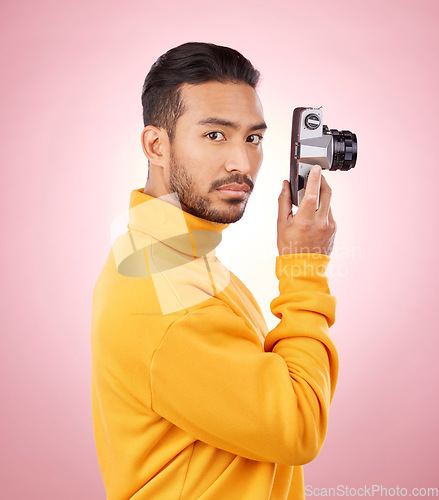 Image of Portrait, man with a camera and creative photography or taking a picture for art, travel or record of a memory. Serious photographer, technology and shooting on retro or vintage film in studio