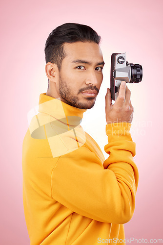 Image of Portrait, man and retro camera for creative photography or taking a picture for art, travel or record of a memory. Serious, creative photographer and shooting on vintage film technology in studio