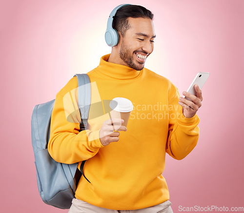 Image of Backpack, phone and man listening to headphones or college podcast, travel and coffee on pink background. E learning mobile and person with bag, music or audio streaming and university chat in studio