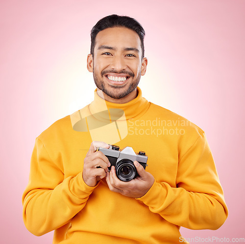 Image of Portrait, photographer with a camera and smile for photography, taking picture for art or travel as cameraman with a happy memory. Creative man on studio background, shooting on retro or vintage film