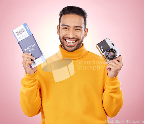 Image of Happy asian man, portrait and passport with camera for travel or photography against a pink studio background. Male person or photographer smile with ticket for flight trip, photo or vacation memory