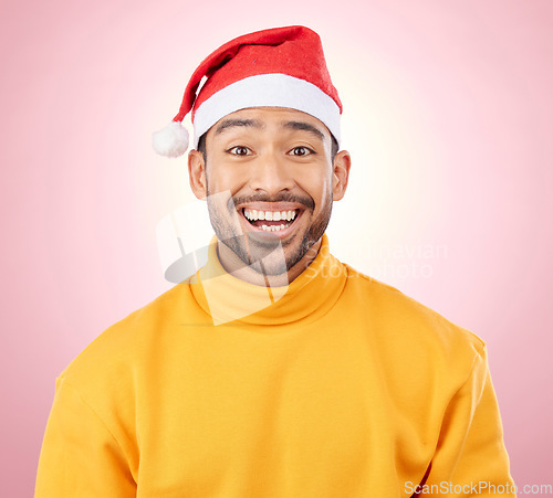 Image of Portrait, surprise and happy man with Christmas hat, fun and festive for holiday on pink background. Happiness, shock and excited model with smile, santa cap and winter vacation fashion in studio.