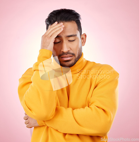 Image of Stress, headache and asian man in studio with depression, broken heart or brain fog on pink background. Anxiety, migraine and Japanese guy in crisis, mistake or fail, vertigo or frustrated by trauma