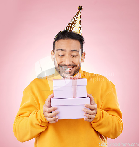 Image of Man, winner and gift box, birthday celebration and prize or giveaway success and shopping on pink background. Happy person with present, party package and retail competition for discount in studio