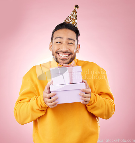 Image of Man, portrait and gift box for birthday, prize and giveaway celebration or success on pink background. Excited asian person or winner with present for retail shopping, competition or sale in studio