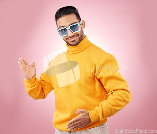 Image of Man, robot dance and sunglasses in studio portrait with smile, moving or fashion for aesthetic by pink background. Asian gen z student, happy and clothes in futuristic glasses, comic dancing or party