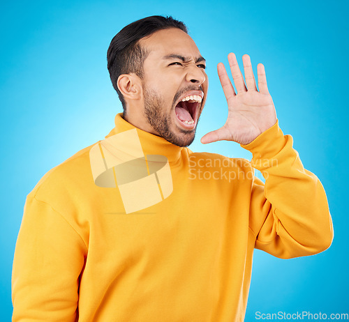 Image of Announcement, hand and young man isolated on blue background for scholarship, sale or university broadcast. Shout, voice and opinion of person or student with college news or attention in studio