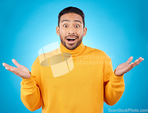 Image of Wow, portrait and asian man in studio with hands for choice, decision or questions on blue background. Palm, scale and face of male customer confused, asking or why emoji for choosing, option or deal