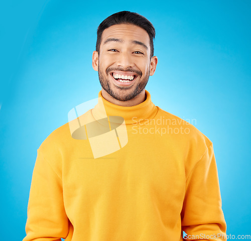 Image of Laugh, portrait and happy asian man in studio with humor, joke or funny smile reaction on blue background. Comedy, face and Japanese guy model, free emotion or good mood, vibes or positive attitude