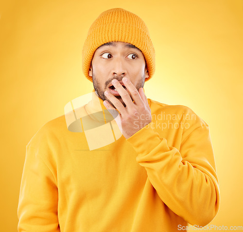 Image of Surprise, hand and asian male shocked by winter, fashion and sale announcement in studio on yellow background. Wtf, worry and Japanese male customer with omg deal, news or coming soon promotion