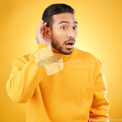 Image of Asian man, listening and gossip with hand on ear in studio background for information. Shock, hearing and male person with surprised face about secret with attention or curiosity in mock up for news.