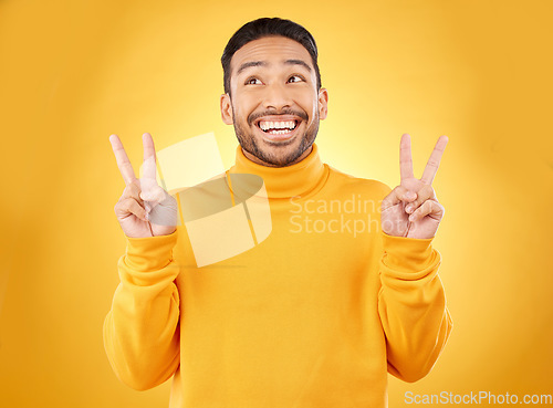 Image of Peace, hands and happy asian man in studio with thank you, vote or feedback on yellow background. V, sign and Japanese male model with emoji fingers, smile and good mood, vibes or positive attitude