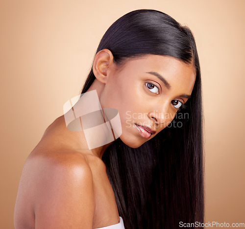 Image of Portrait, hair care and Indian woman with beauty, cosmetics and dermatology on a brown studio background. Face, female person or model with volume, skincare and scalp treatment with beauty and luxury