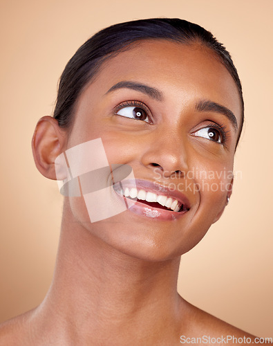 Image of Face, beauty and happy woman, natural and cosmetics with skincare isolated on blue background. Indian female model, healthy glow and clean skin, dermatology and wellness with spa facial in a studio