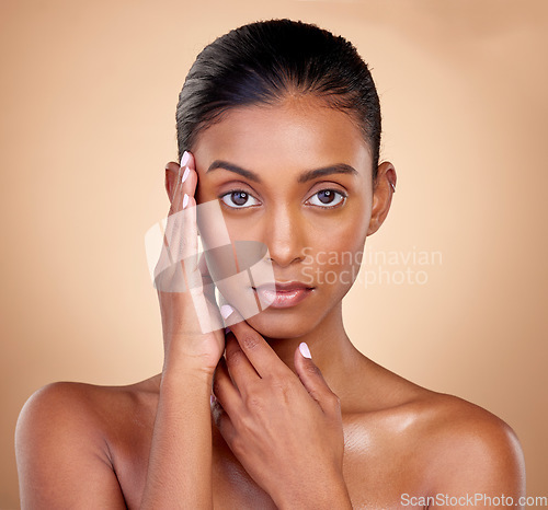 Image of Portrait, makeup and Indian woman with cosmetics, dermatology and wellness against a brown studio background. Face, female person and model with health, luxury and aesthetic with self care and beauty