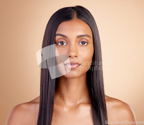 Image of Portrait, hair care and Indian woman with beauty, cosmetics and dermatology on a brown studio background. Face, female person or model with volume, wellness or scalp treatment with aesthetic or shine