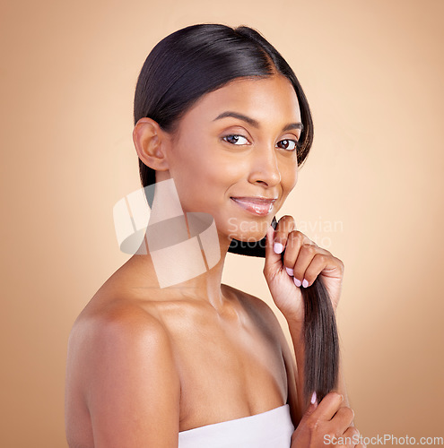 Image of Portrait, hair care and Indian woman, with beauty, cosmetics and dermatology against a brown studio background. Face, female person or model with luxury, shine and glow with volume, growth or texture