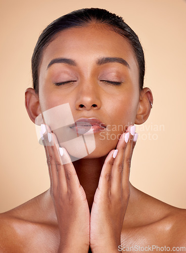 Image of Relax, skincare or natural woman with wellness, beauty or facial glow with dermatology cosmetics in studio. Hands, background or face of Indian girl model resting with shine, eyes closed or self love