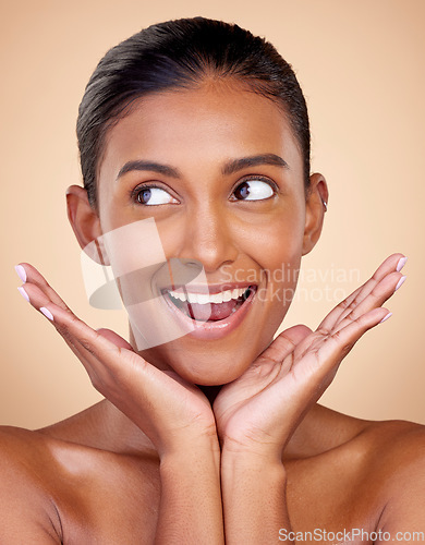 Image of Thinking, beauty or happy woman with natural facial glow with dermatology skincare cosmetics in studio. Hands, background or face of Indian girl model smiling with health ideas, wellness or self love