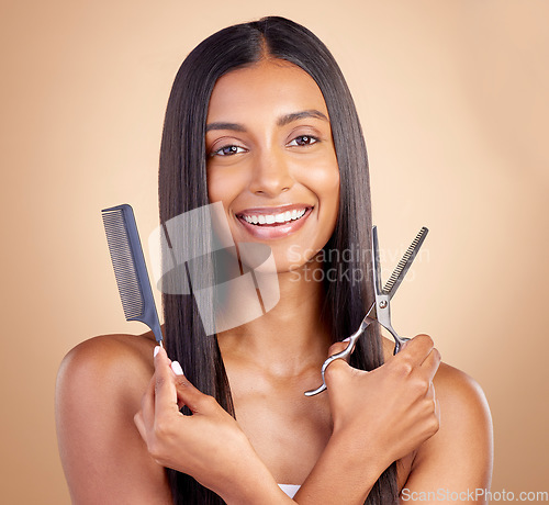 Image of Hair care, happy and portrait of a woman with tools for a haircut, grooming or salon treatment. Smile, Indian and a young model or girl with gear for a hairstyle isolated on a studio background