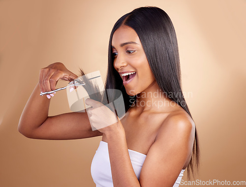 Image of Surprise, cut and face of Indian woman with scissors in studio for diy, haircut or styling on brown background. Wow, choice and female model with hair, treatment or styling results with beauty tool