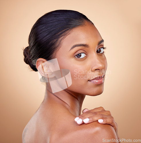 Image of Portrait, beauty or Indian woman with natural facial glow with dermatology skincare cosmetics in studio. Aesthetic face, brown background or girl model with wellness, makeup shine or self love
