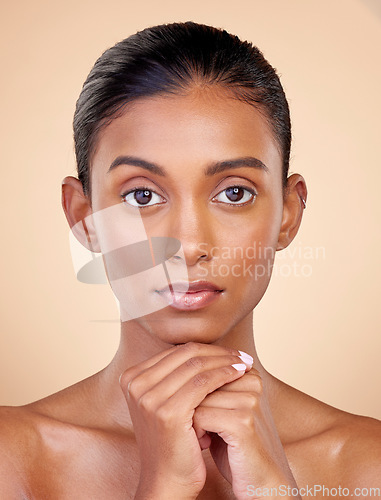 Image of Portrait, skincare and woman with self care, cosmetics and luxury on a brown studio background. Face, female person or model with makeup, shine and glow with natural beauty, dermatology and aesthetic