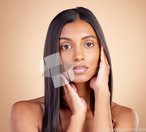 Image of Portrait, hair care and Indian woman with cosmetics, makeup and skincare on a brown studio background. Face, female person and model with volume, texture and scalp treatment with natural beauty
