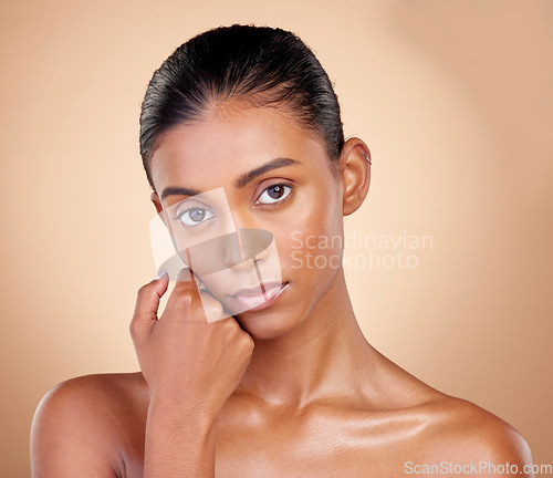 Image of Skincare, beauty and portrait with indian girl with glow in brown studio background. Natural, serious face and dermatology with cosmetics for luxury facial for spa treatment with self care in mock up
