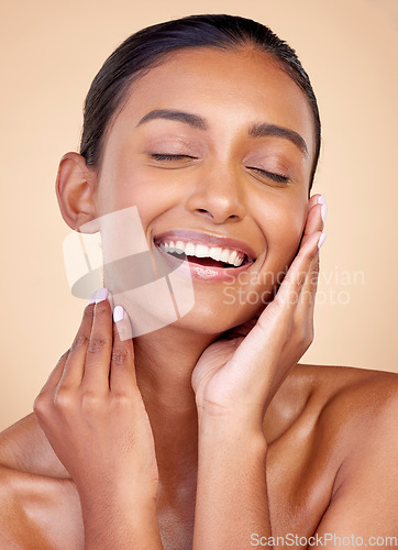 Image of Skincare, funny and Indian woman with cosmetics, facial and dermatology on a brown studio background. Female person, aesthetic and model with treatment, laughing and shine with self care and wellness