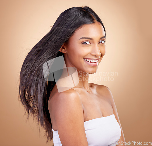 Image of Hairstyle, salon and beauty with indian woman healthy shine in brown studio background. Haircare, girl and happy with wind for growth or keratin treatment with shine and natural cosmetic in mockup.
