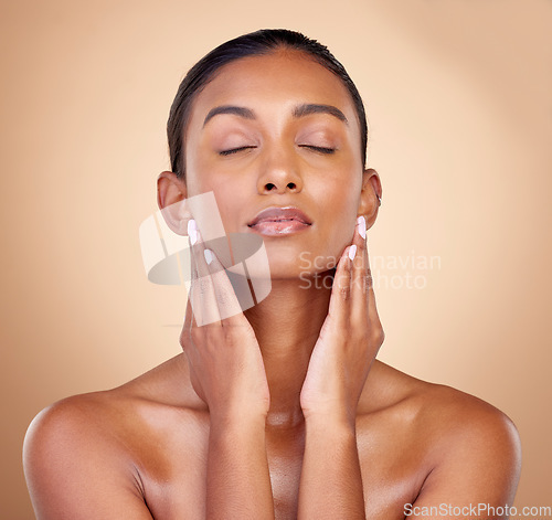 Image of Skincare, studio face and woman relax with natural foundation makeup, aesthetic cosmetics or self care routine. Spa salon, collagen shine or clean Indian person with facial beauty on brown background