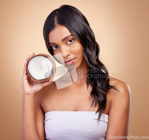 Image of Coconut, fruit and portrait of woman with natural beauty, skincare or vegan product in cosmetics for healthy skin glow or benefits. Tropical fruits, Indian model and organic oil for facial cream