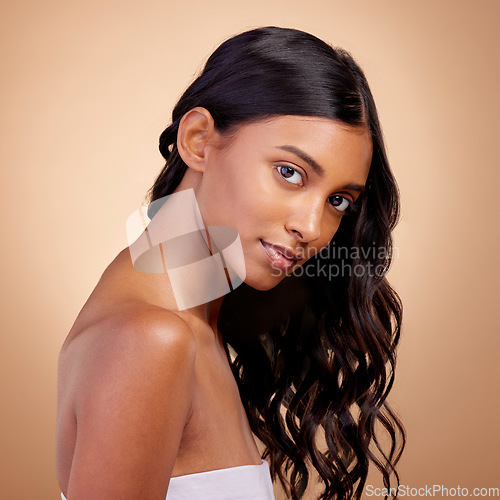 Image of Balayage, hair and woman in portrait, beauty and shine with cosmetic care isolated on studio background. Female model, haircare and growth, cosmetology and texture with growth and curly hairstyle