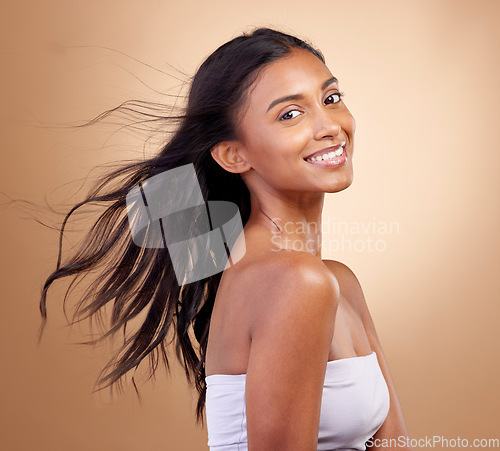 Image of Portrait, haircare and salon for indian woman with beauty in brown studio background with glow. Hairstyle, happy face and girl with shine or keratin treatment, volume and natural cosmetic in mockup.