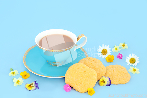 Image of Afternoon Tea For One with Teacup Cookies and Spring Flowers