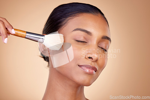 Image of Beauty, makeup and relax with woman and brush in studio for facial, foundation and self care. Cosmetics, product and tools with face of model on brown background for glow, skincare and dermatology
