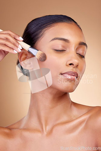 Image of Beauty, makeup and product with woman and brush in studio for facial, foundation and self care. Cosmetics, spa and tools with face of model on brown background for glow, skincare and dermatology