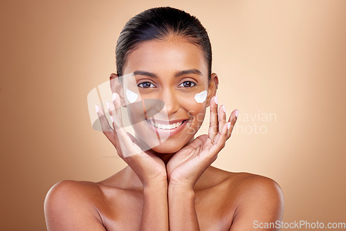 Image of Facial cream, skincare or portrait of happy woman for aesthetic shine, cosmetics or dermatology on studio background. Indian female model, face lotion or product for healthy beauty, glow or self care