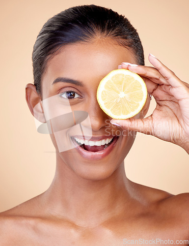 Image of Lemon, beauty and portrait of happy woman in studio for vitamin c nutrition, spa or natural cosmetics. Face of indian female model, healthy skincare or citrus fruit in dermatology, vegan diet or glow