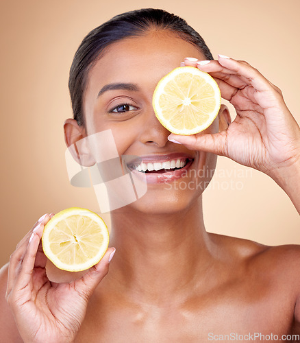 Image of Lemon fruit, portrait and skincare of woman in studio for vitamin c benefits, eco cosmetics or nutrition. Face of indian female model, natural beauty and healthy citrus food for aesthetic dermatology