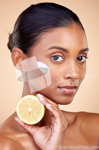 Image of Woman, portrait and cream with lemon for skincare, cosmetics cleaning and natural beauty product or vitamin c benefits. Face of young person with fruits for dermatology on studio, brown background