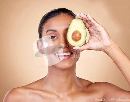 Image of Avocado, cream and beauty with portrait of woman in studio for product, skincare and natural cosmetics. Spa, facial and lotion with face of model on brown background for vitamin c and self care