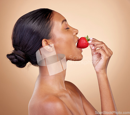 Image of Woman, eating a strawberry and skincare with natural beauty or benefits from healthy nutrition, diet and fruit. Girl, profile and food with vitamin c for skin to glow, shine or wellness of body