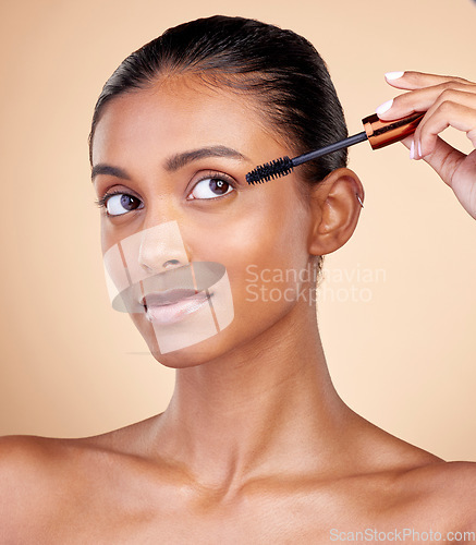 Image of Beauty, makeup and mascara with face of woman in studio for cosmetics, eyelashes and glamour. Self care, application and tools with female model on brown background for product, volume and glow